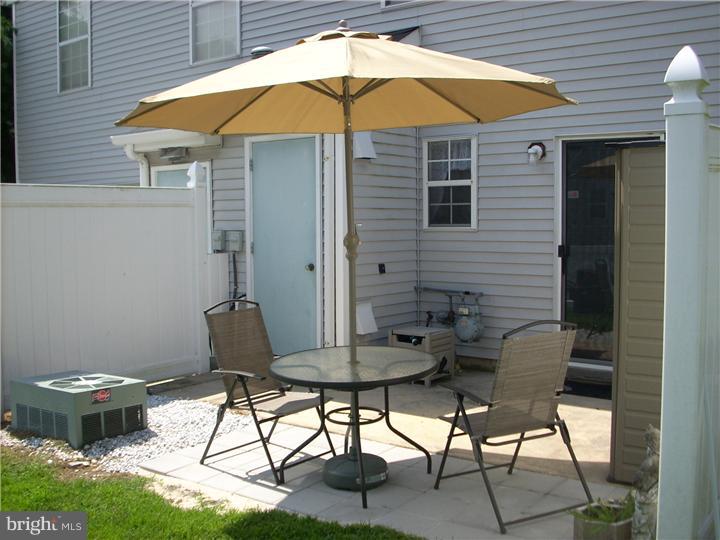 711 Rutland Court Sewell, NJ 08080 - Photo 15 of 18 a backyard of a house with table and chairs