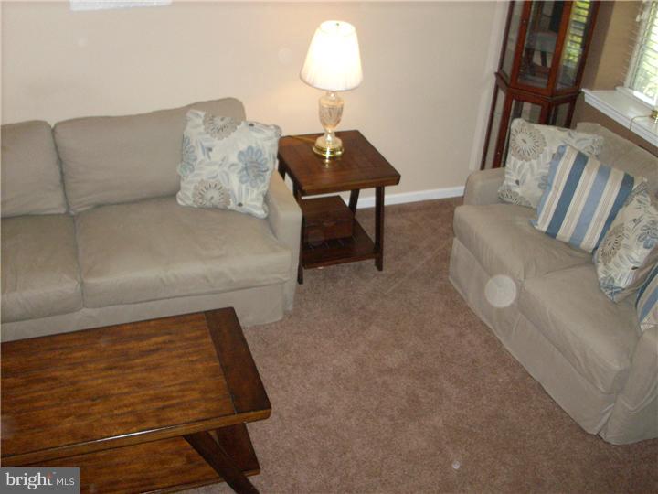 711 Rutland Court Sewell, NJ 08080 - Photo 4 of 18 a living room with furniture and a lamp