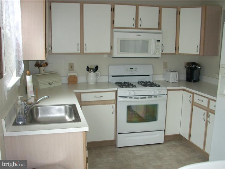 711 Rutland Court Sewell, NJ 08080 - Photo 5 of 18 a kitchen with a sink a stove and cabinets