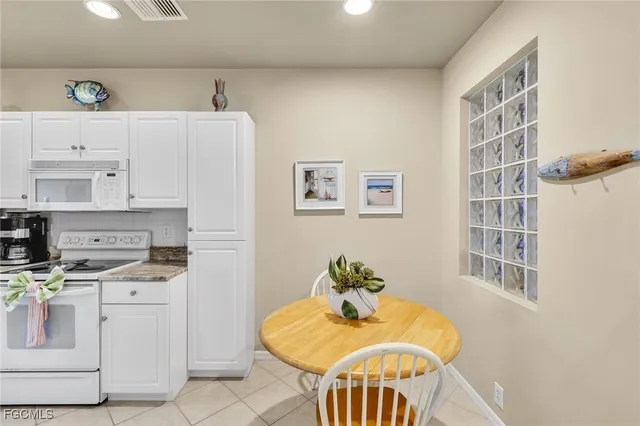 a livingroom with furniture and a dining table