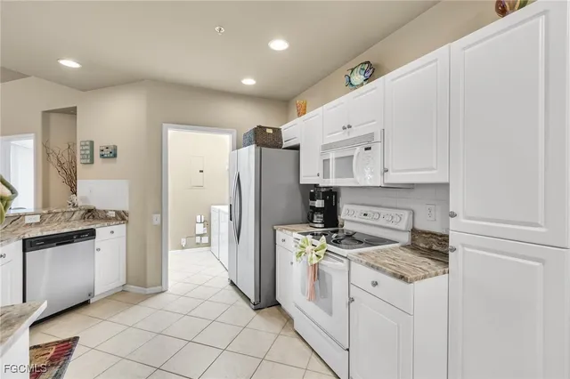 a kitchen with cabinets and stainless steel appliances