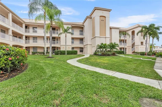 a view of a big building with a big yard and plants