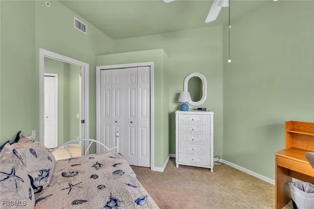 a bedroom with a bed and a mirror