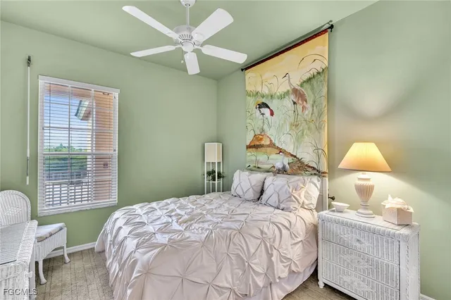 a bedroom with a bed and a painting on the wall