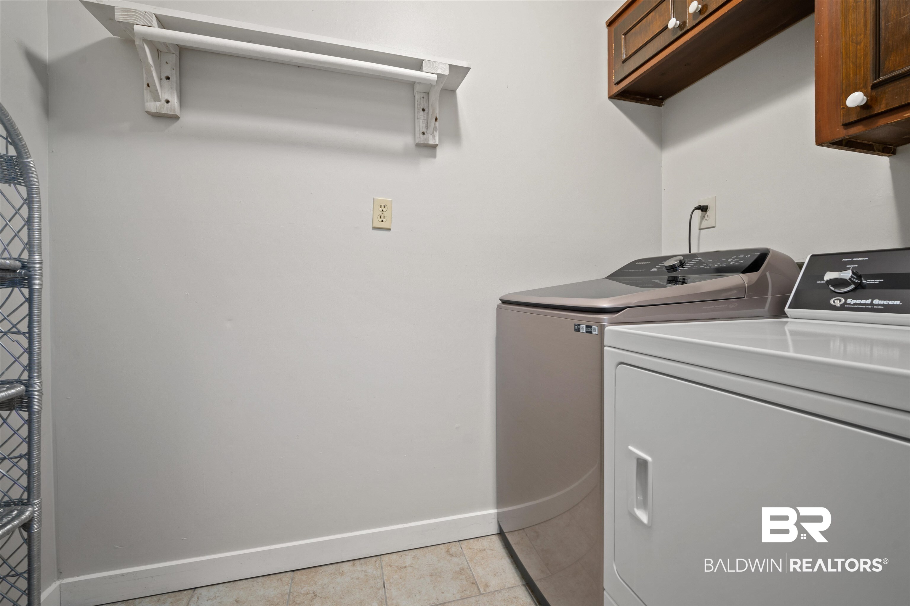 7912 Yorkhaven Road Mobile, AL 36695 - Photo 27 of 41 Laundry area with light tile patterned floors, washer and clothes dryer, and cabinet space