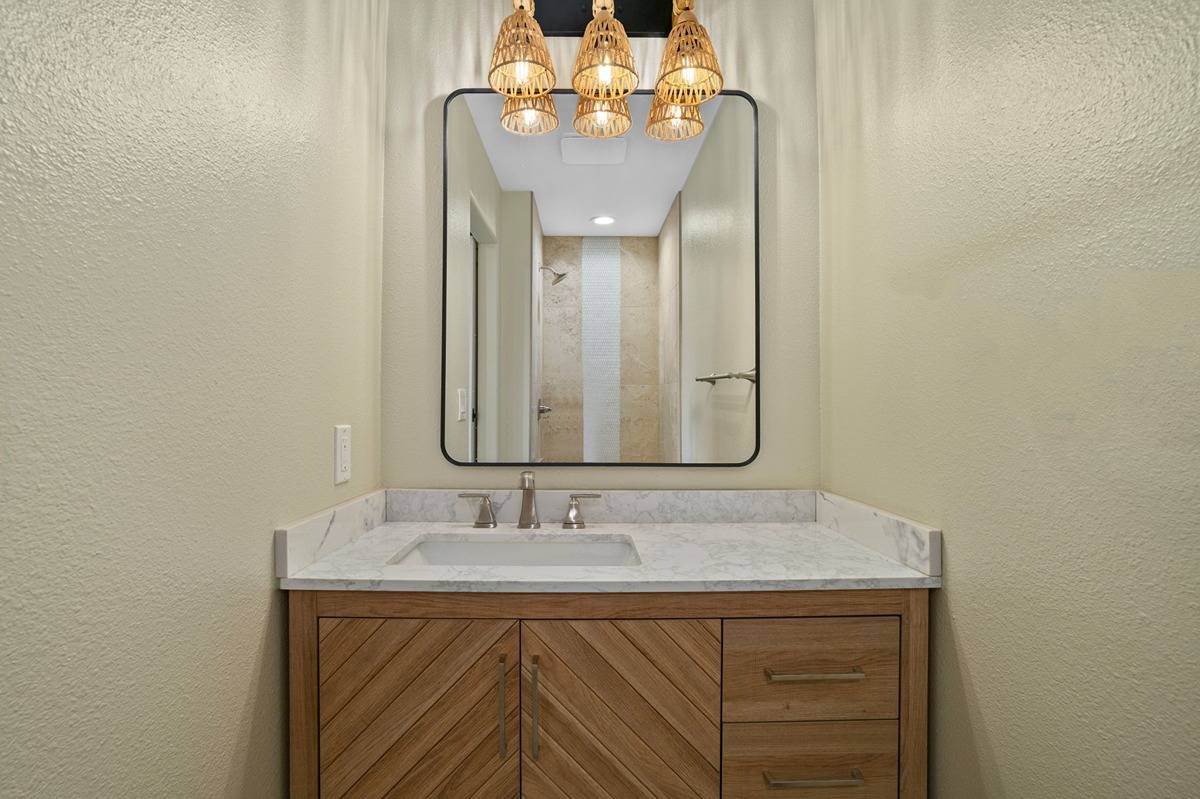 4510 Kuli Road Kalaheo, HI 96741 - Photo 17 of 24 a bathroom with a sink and a mirror