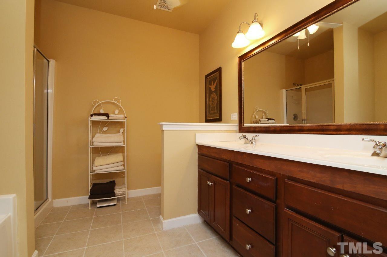 12302 Mossgreen Street Raleigh, NC 27614 - Photo 13 of 25 Master bath has a double vanity with custom framed mirror.