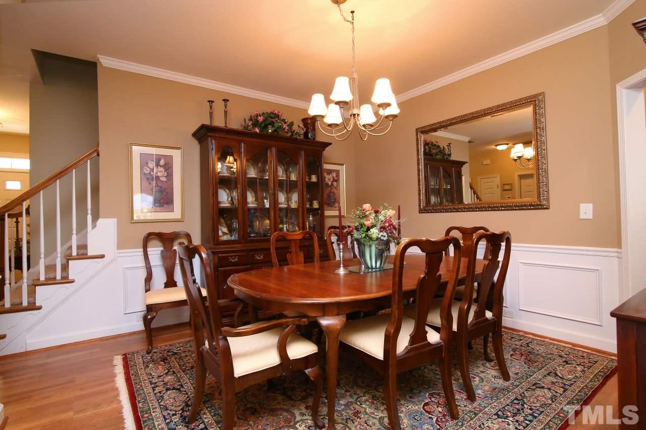 12302 Mossgreen Street Raleigh, NC 27614 - Photo 5 of 25 The spacious dining room has crown moulding, wainscoting & custom paint.