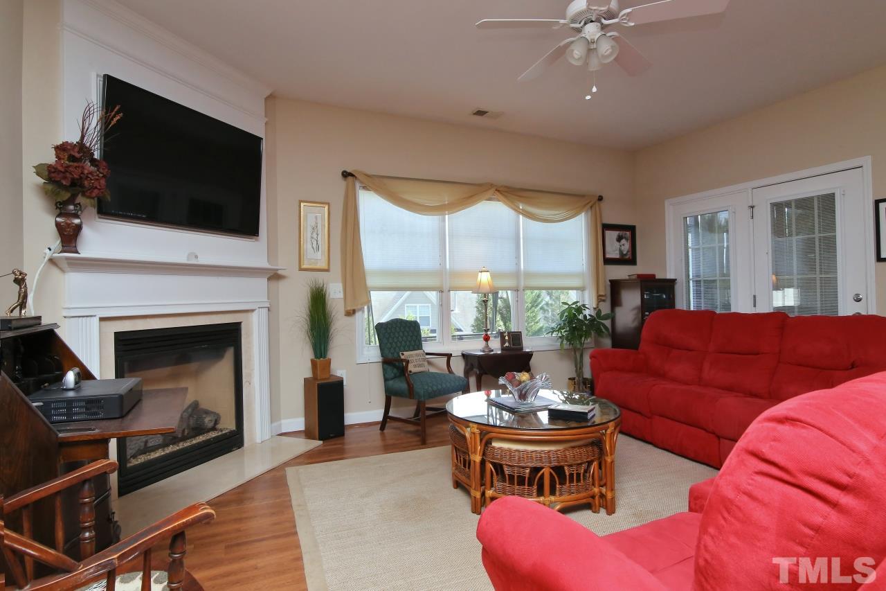 12302 Mossgreen Street Raleigh, NC 27614 - Photo 9 of 25 This large family room has a gas log fireplace, ceiling fan and lovely windows!
