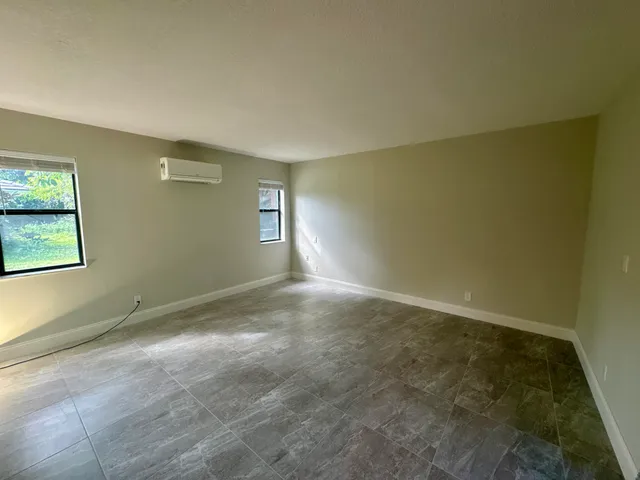 an empty room with large windows