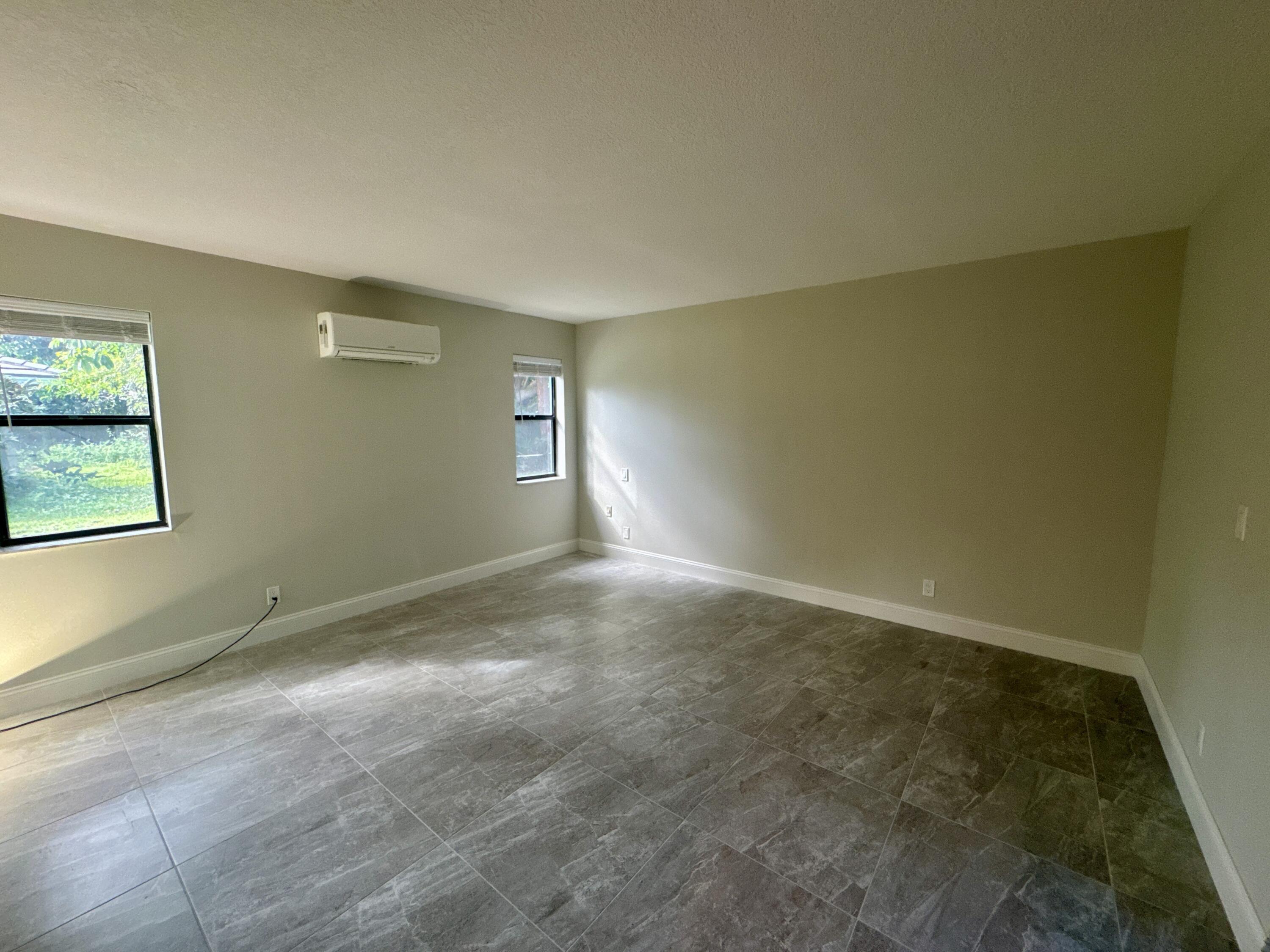 4160 Northwest 7th Court Delray Beach, FL 33445 - Photo 17 of 46 an empty room with windows