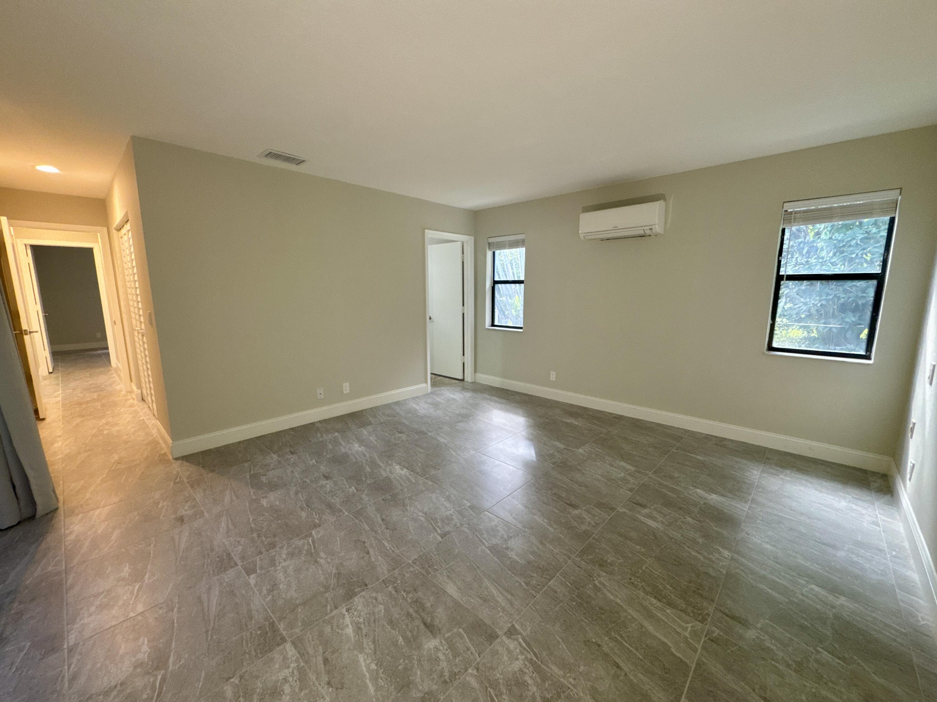 4160 Northwest 7th Court Delray Beach, FL 33445 - Photo 19 of 46 a view of empty room with wooden floor and fan