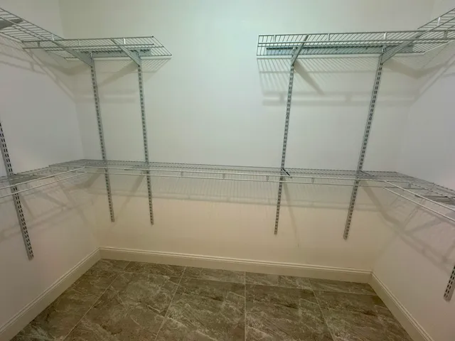 a bathroom with double vanity and a shower