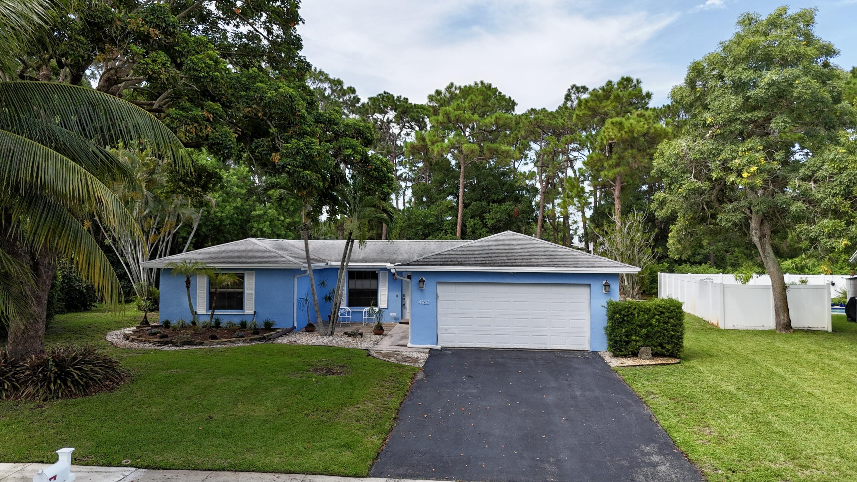 4160 Northwest 7th Court Delray Beach, FL 33445 - Photo 2 of 46 a front view of a house with a yard