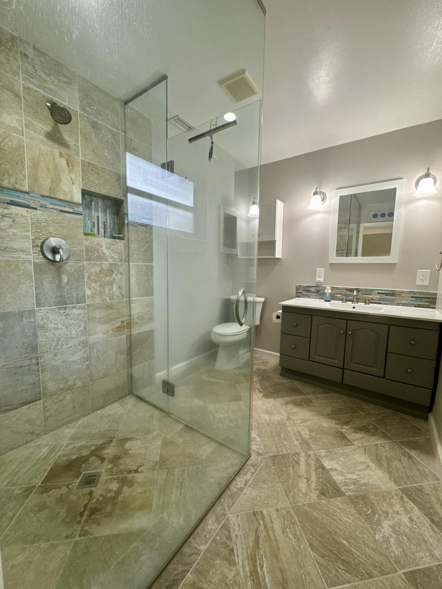 4160 Northwest 7th Court Delray Beach, FL 33445 - Photo 21 of 46 a bathroom with double vanity and a shower