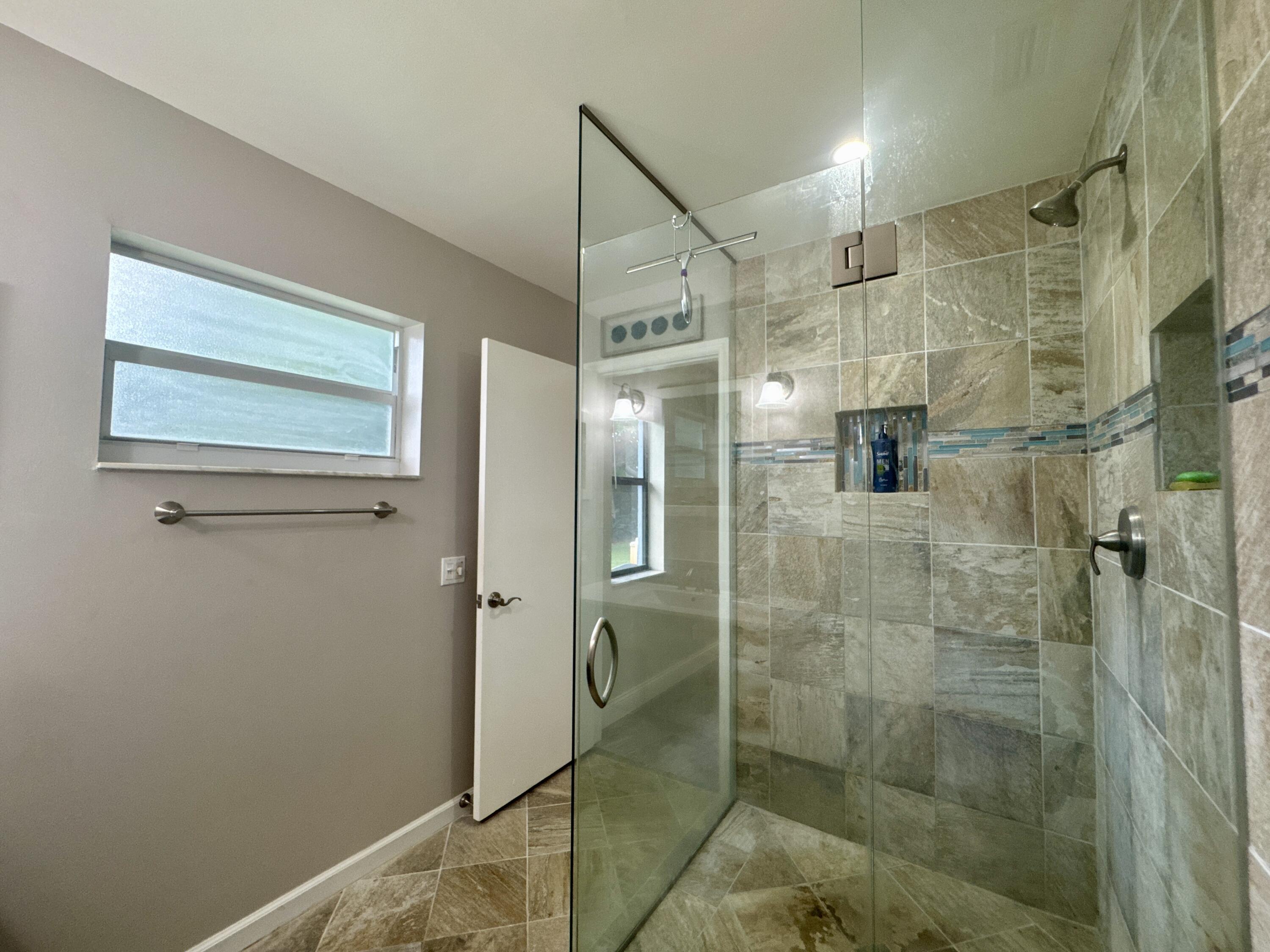 4160 Northwest 7th Court Delray Beach, FL 33445 - Photo 22 of 46 a bathroom with a shower