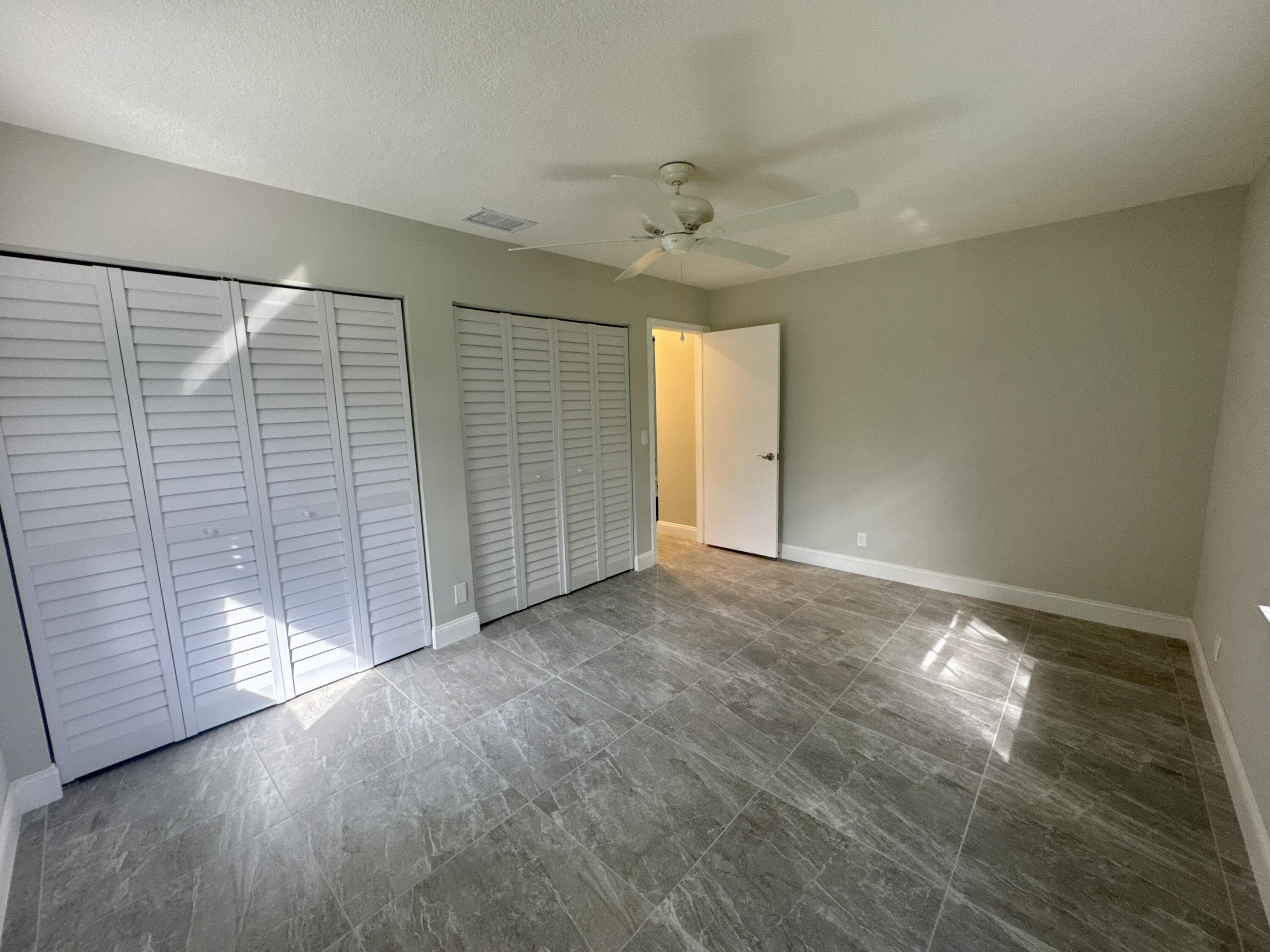 4160 Northwest 7th Court Delray Beach, FL 33445 - Photo 26 of 46 an empty room with windows and closet