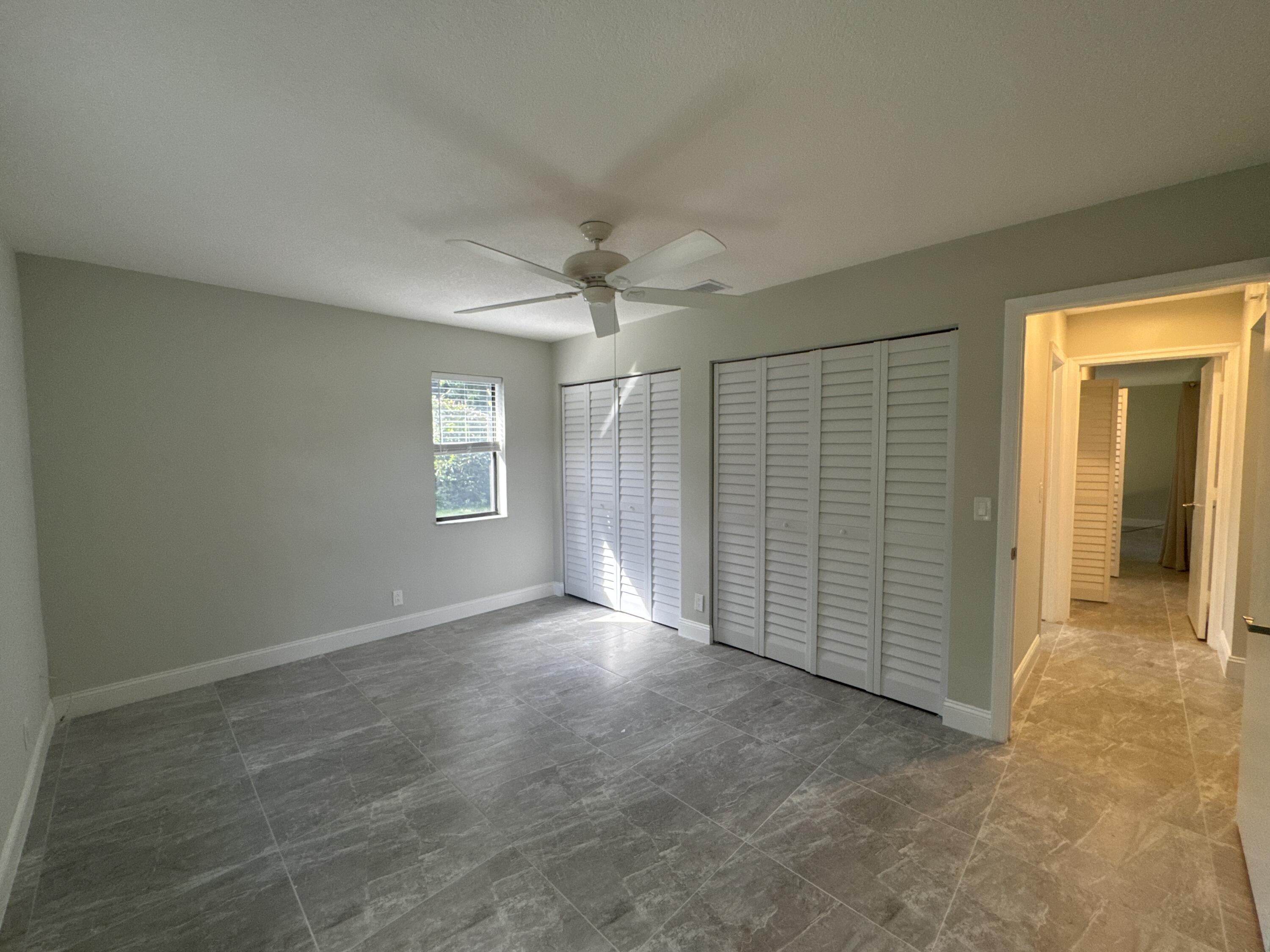 4160 Northwest 7th Court Delray Beach, FL 33445 - Photo 27 of 46 an empty room with windows and closet