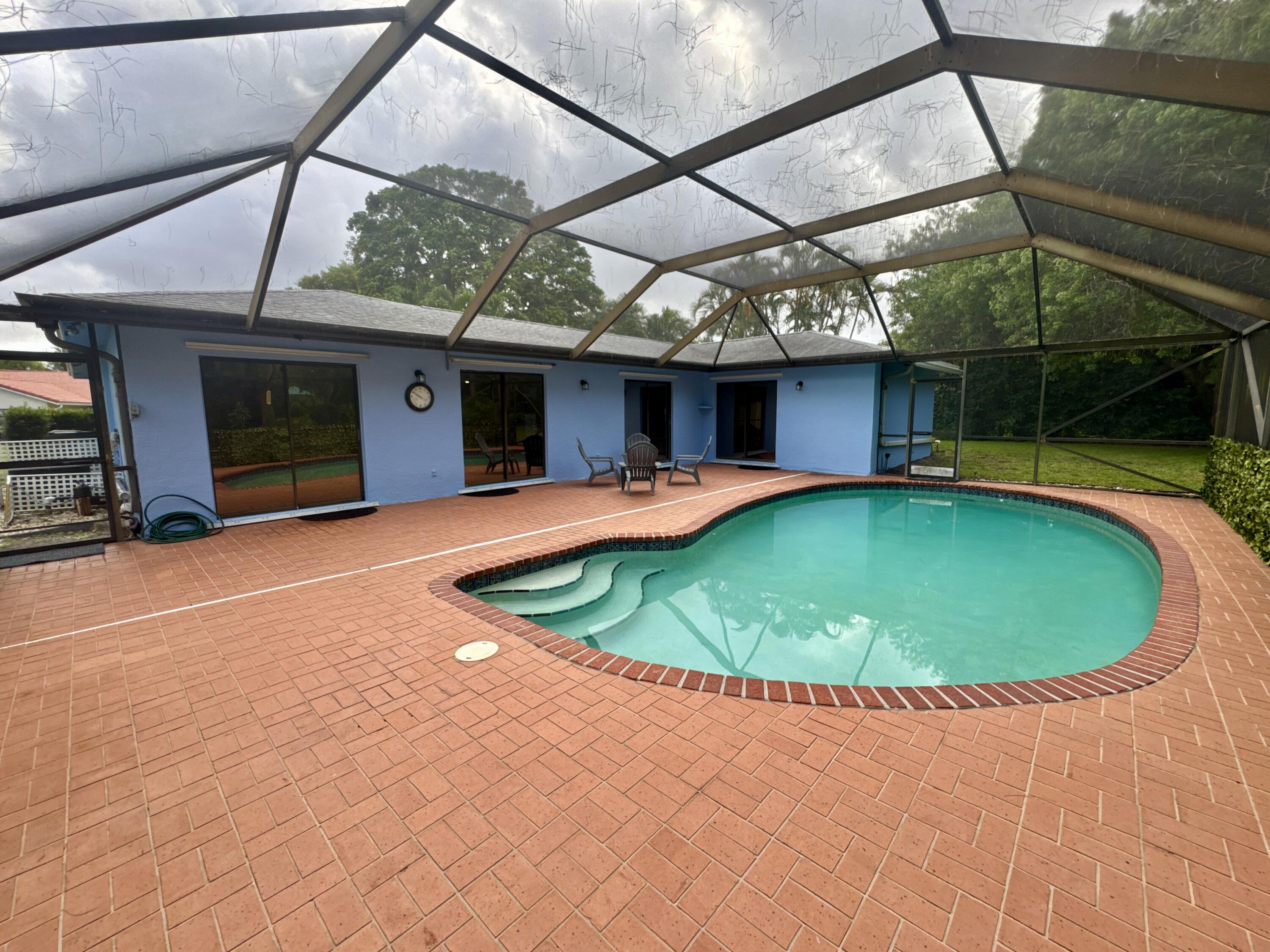 4160 Northwest 7th Court Delray Beach, FL 33445 - Photo 33 of 46 a view of a swimming pool with a patio