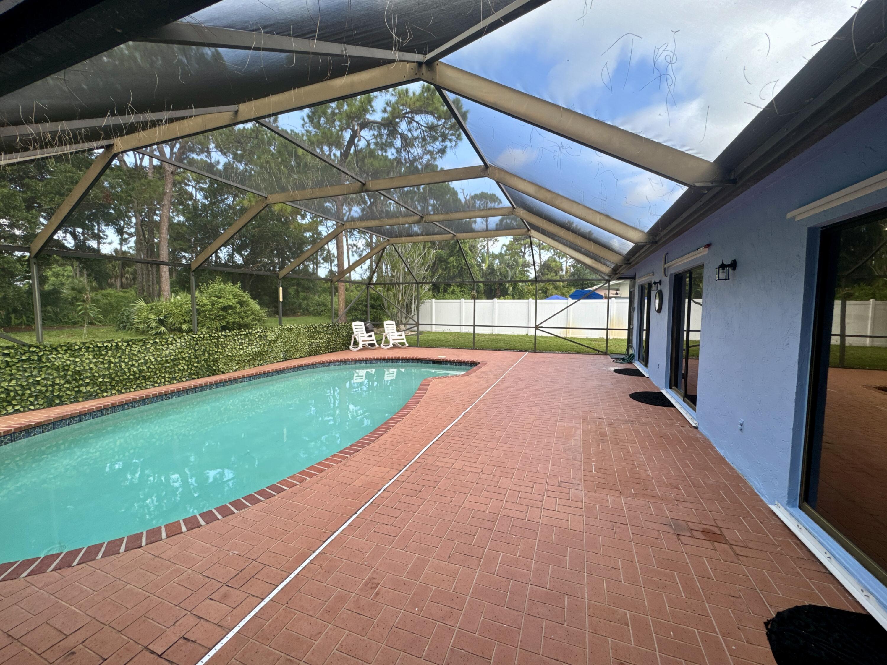 4160 Northwest 7th Court Delray Beach, FL 33445 - Photo 35 of 46 a view of swimming pool with a backyard