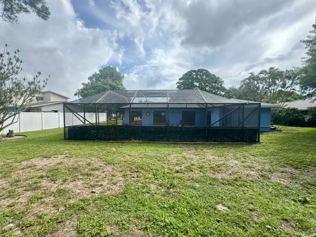 an aerial view of a house with a yard and garden