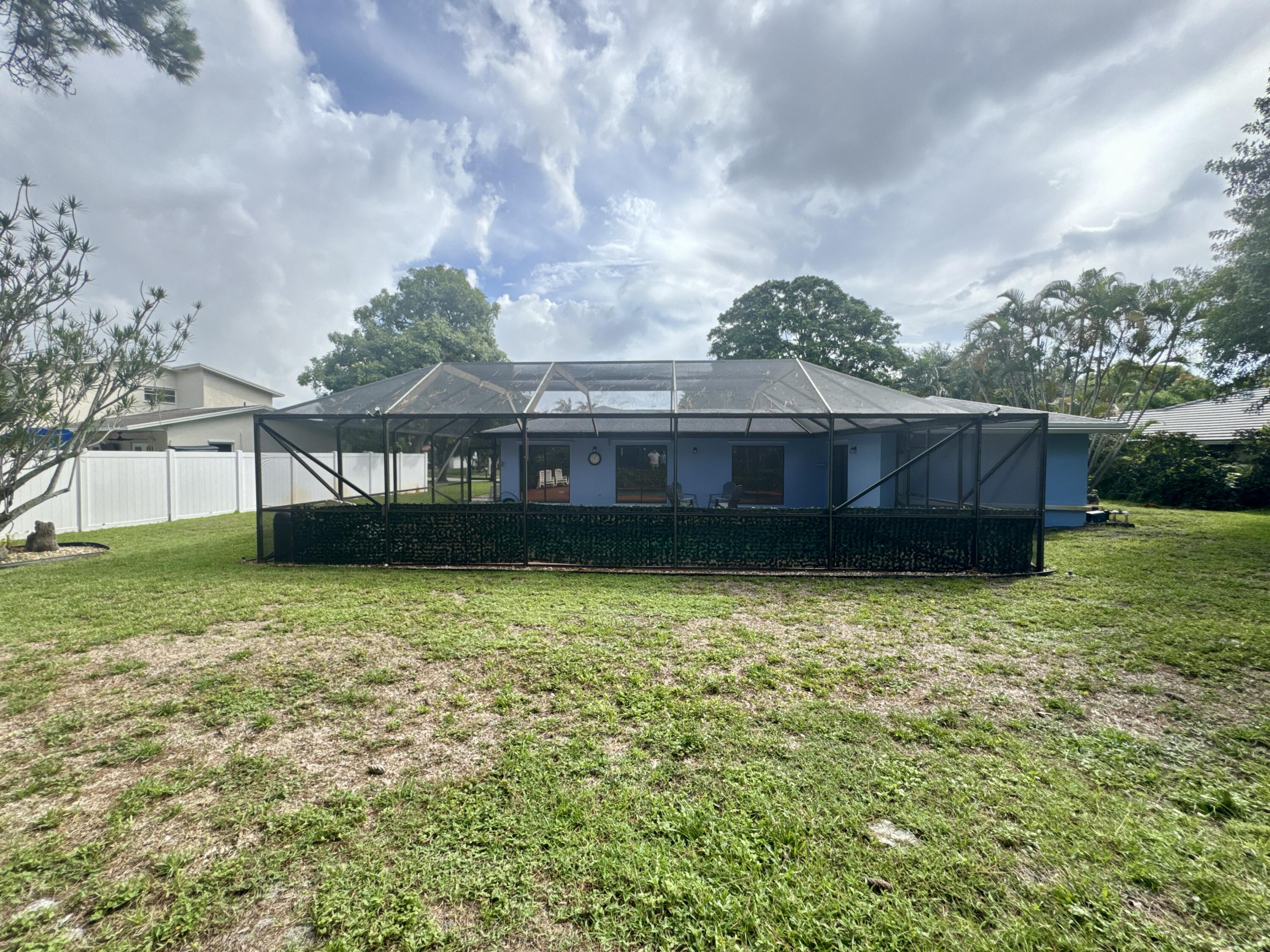 4160 Northwest 7th Court Delray Beach, FL 33445 - Photo 36 of 46 a view of a house with a backyard