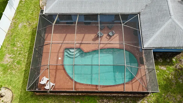an aerial view of a house with a garden and swimming pool