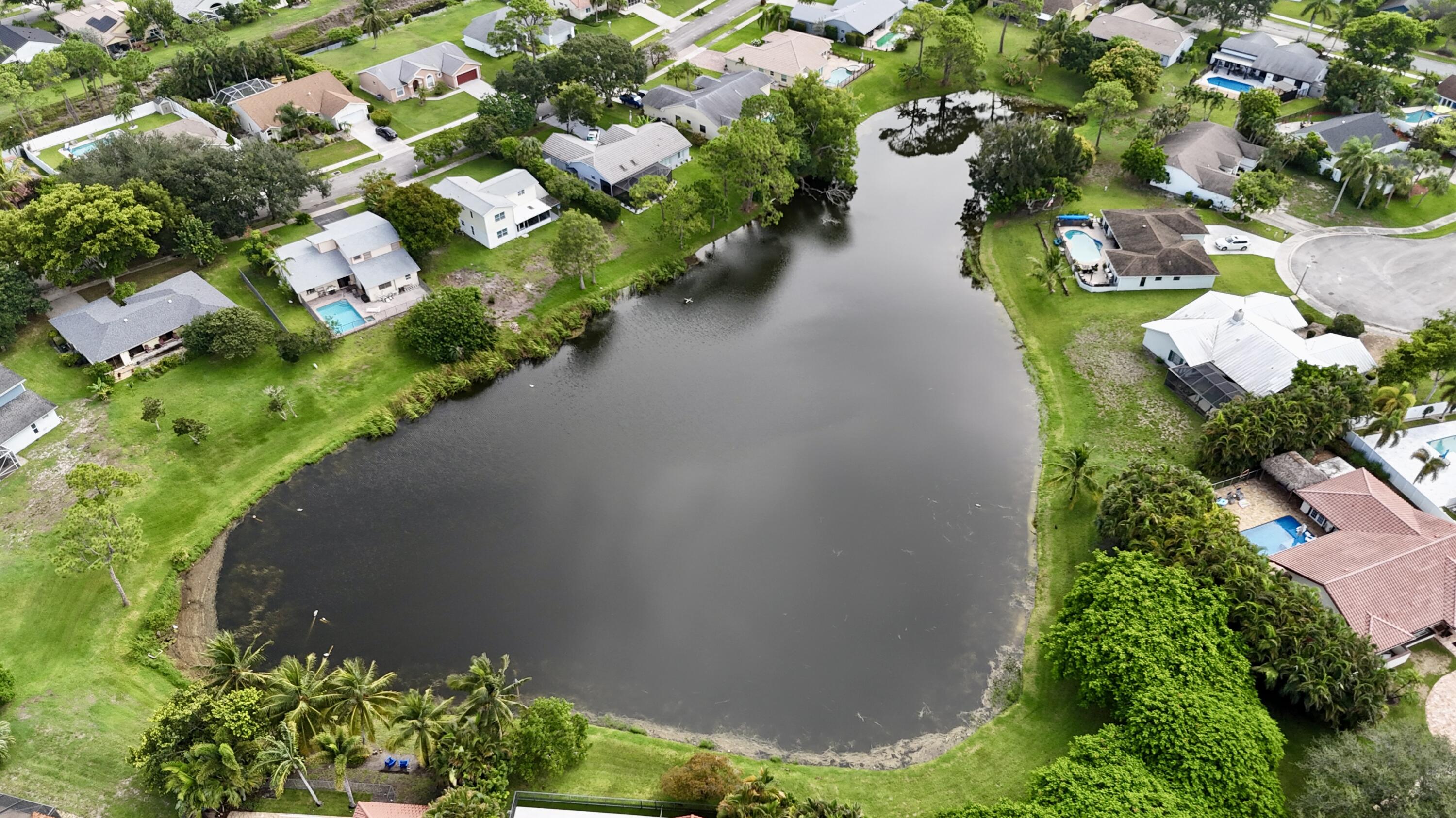 4160 Northwest 7th Court Delray Beach, FL 33445 - Photo 42 of 46 an aerial view of a house with a yard and garden
