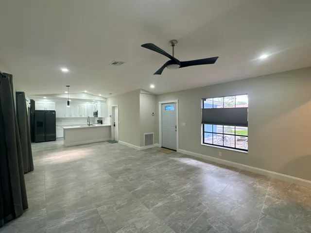 a view of an empty room and a window