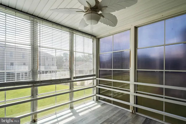 a view of a room with a ceiling fan