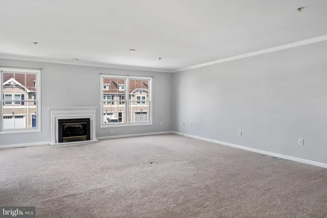 a view of a livingroom with a fireplace and window