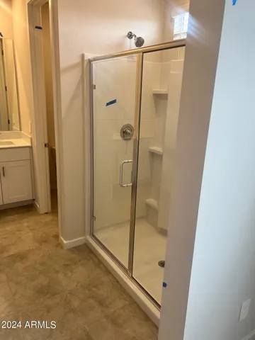 a bathroom with a glass shower door