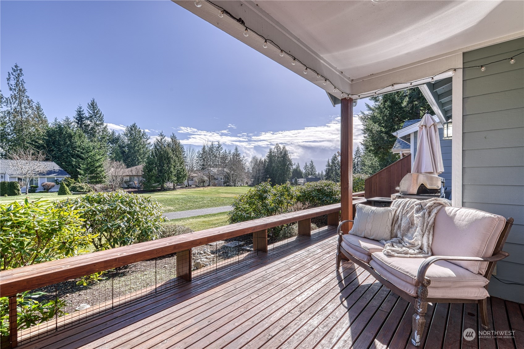 91 East Soderberg Road, Unit B5 Allyn, WA 98524 - Photo 1 of 34 a view of balcony with furniture and wooden floor