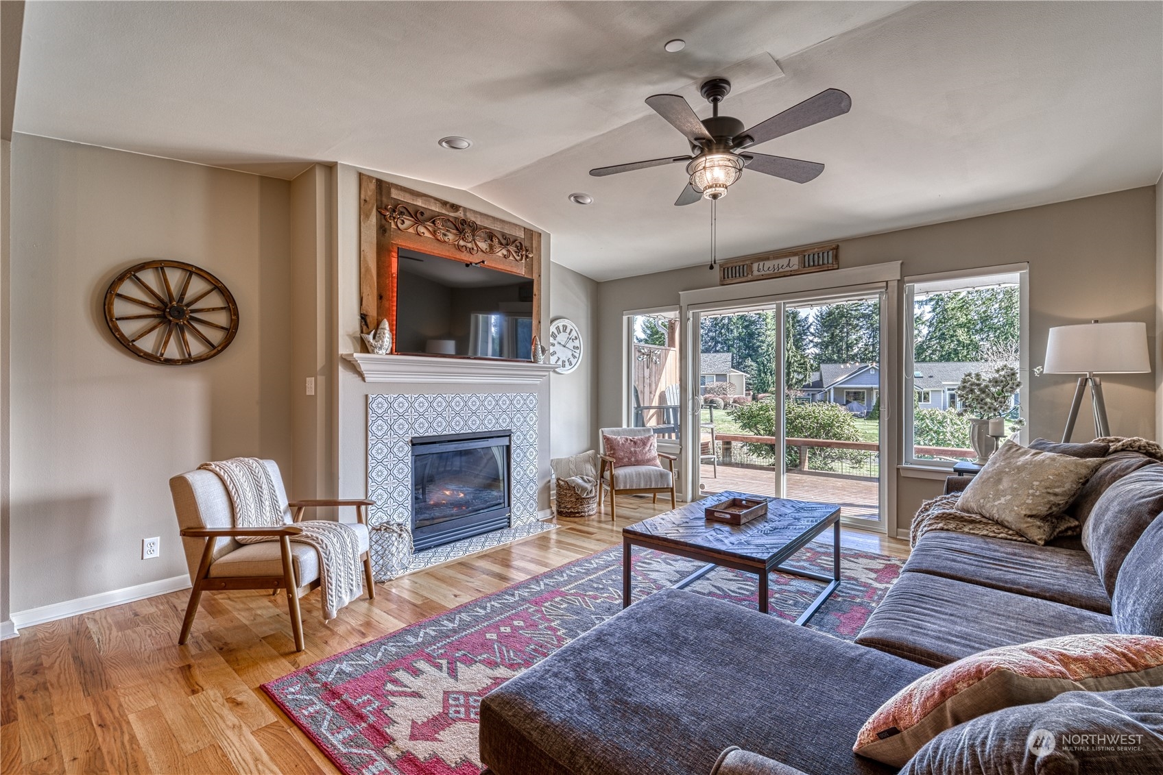 91 East Soderberg Road, Unit B5 Allyn, WA 98524 - Photo 11 of 34 a living room with furniture a fireplace and a floor to ceiling window