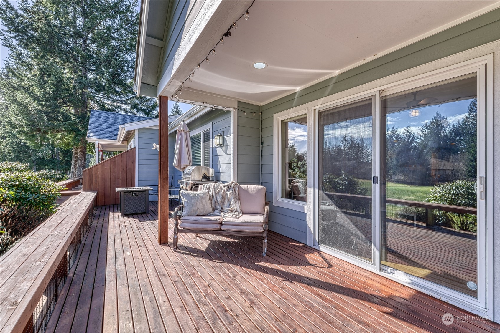91 East Soderberg Road, Unit B5 Allyn, WA 98524 - Photo 13 of 34 a view of living room and deck with wooden floor and fence