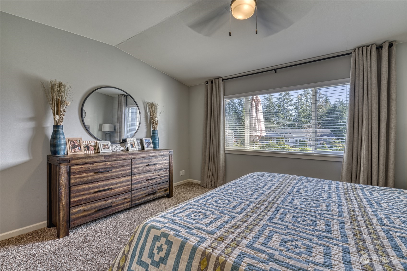 91 East Soderberg Road, Unit B5 Allyn, WA 98524 - Photo 19 of 34 a bedroom with a bed and a dresser next to a window