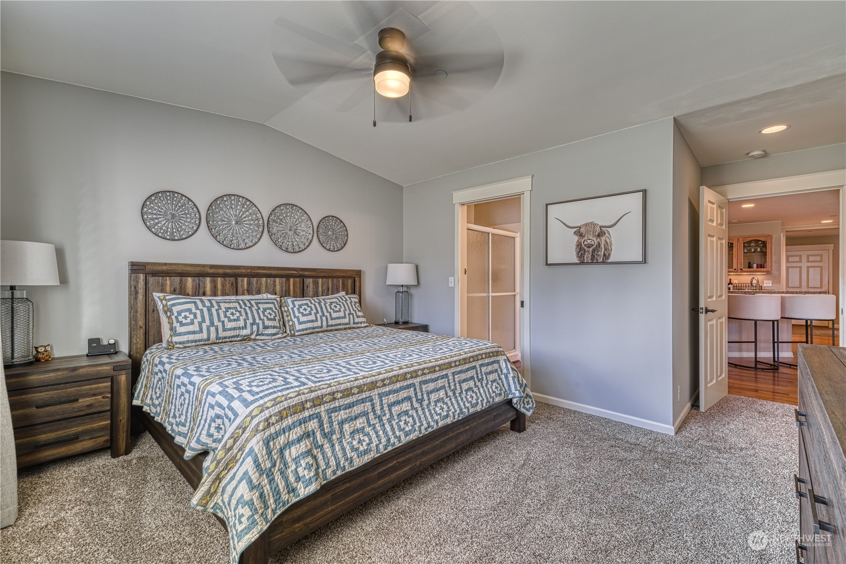 91 East Soderberg Road, Unit B5 Allyn, WA 98524 - Photo 20 of 34 a bedroom with a bed and a chandelier