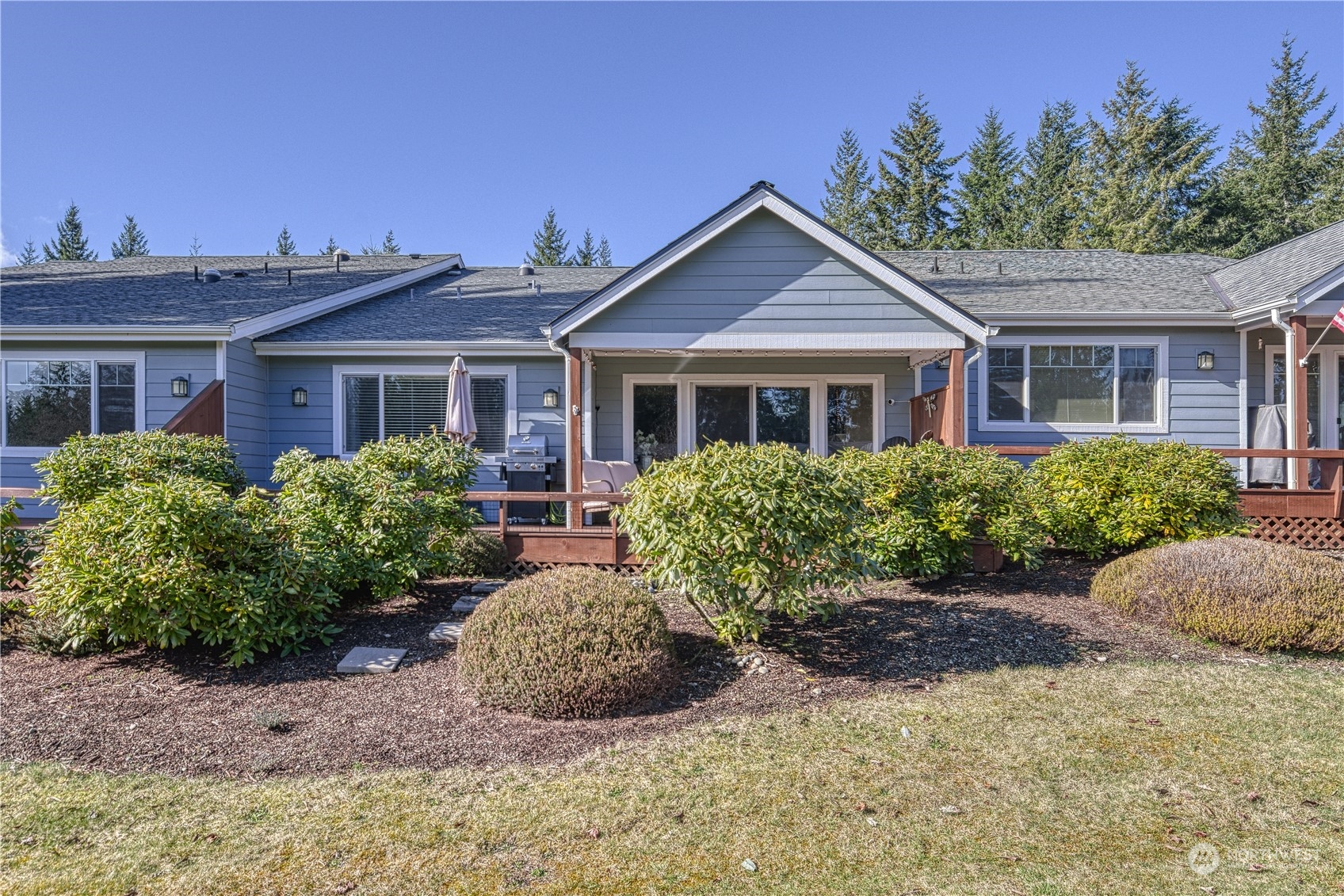 91 East Soderberg Road, Unit B5 Allyn, WA 98524 - Photo 2 of 34 front view of a house with a yard