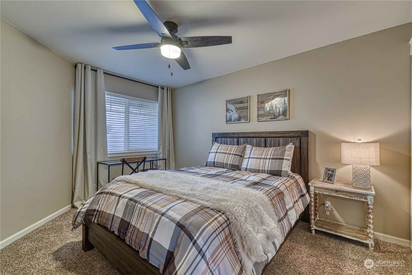 91 East Soderberg Road, Unit B5 Allyn, WA 98524 - Photo 23 of 34 a bedroom with a bed and a chandelier