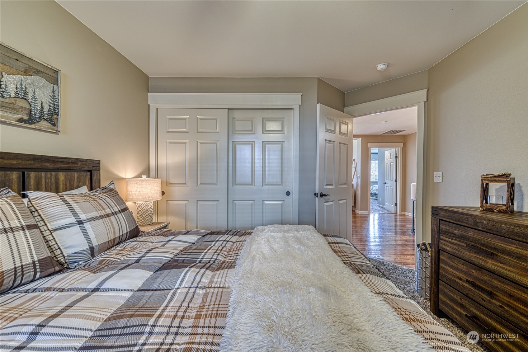 91 East Soderberg Road, Unit B5 Allyn, WA 98524 - Photo 24 of 34 a bedroom with a bed and wooden floor