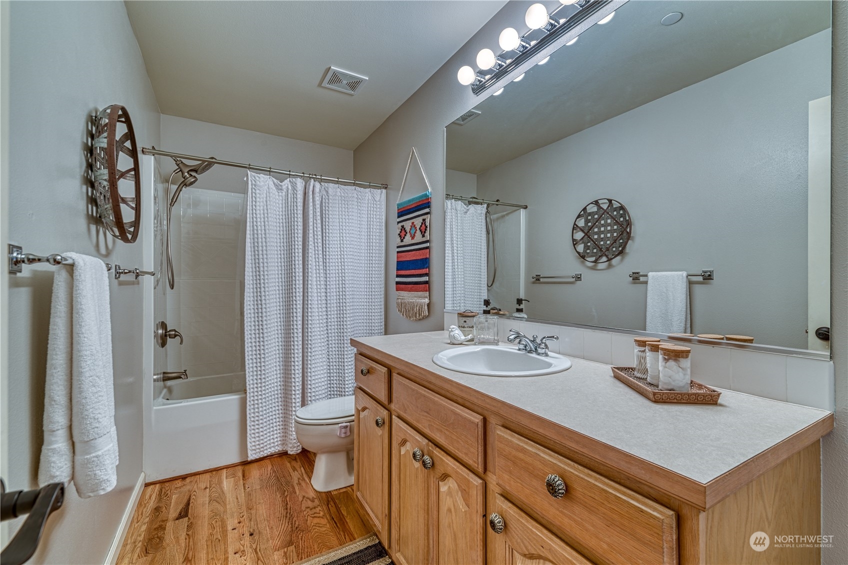 91 East Soderberg Road, Unit B5 Allyn, WA 98524 - Photo 25 of 34 a bathroom with a sink a toilet a mirror and shower