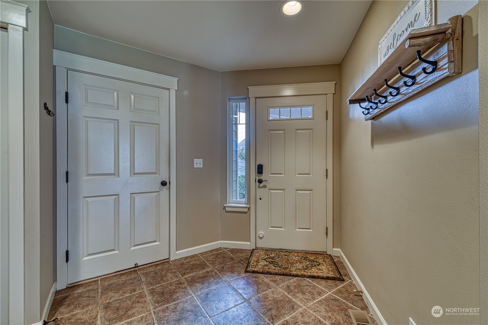 91 East Soderberg Road, Unit B5 Allyn, WA 98524 - Photo 4 of 34 a view of a hallway with wooden floor and a bathroom