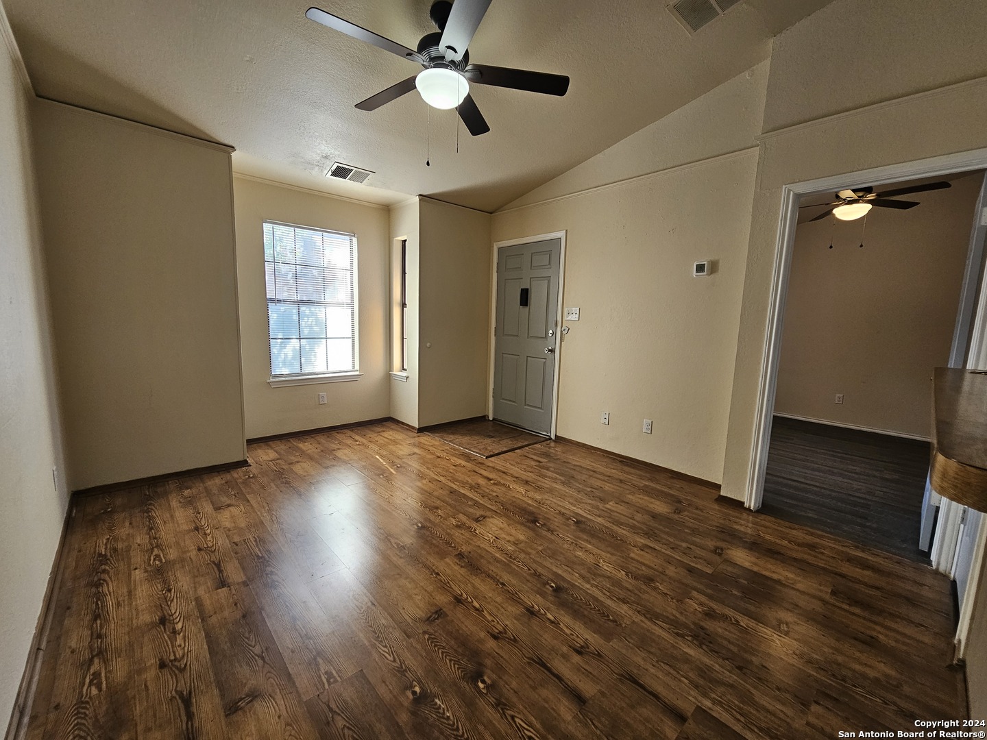 4803 Hamilton Wolfe Road, Unit 312 San Antonio, TX 78229 - Photo 9 of 13 wooden floor in an empty room with a window