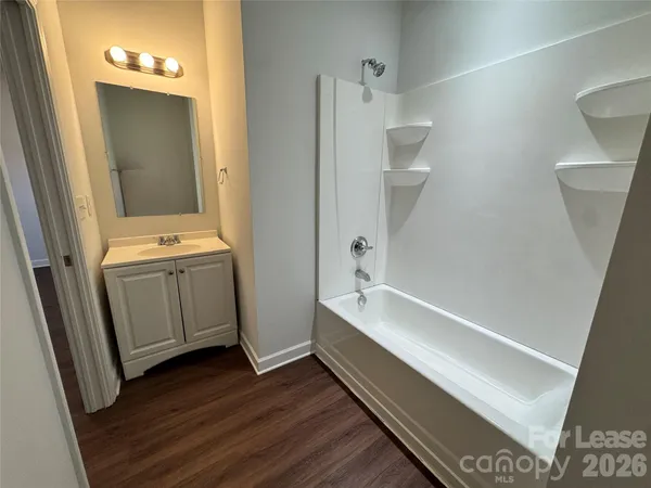 a bathroom with a bathtub and a sink
