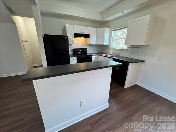 a kitchen with stainless steel appliances a refrigerator sink and microwave