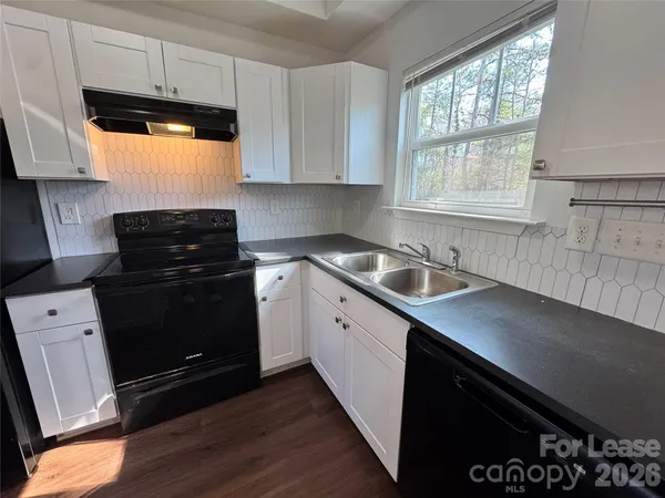 a kitchen with a sink stove and microwave
