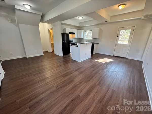 a view of a kitchen with a sink and a refrigerator