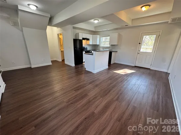 a kitchen with stainless steel appliances granite countertop a refrigerator and a stove top oven