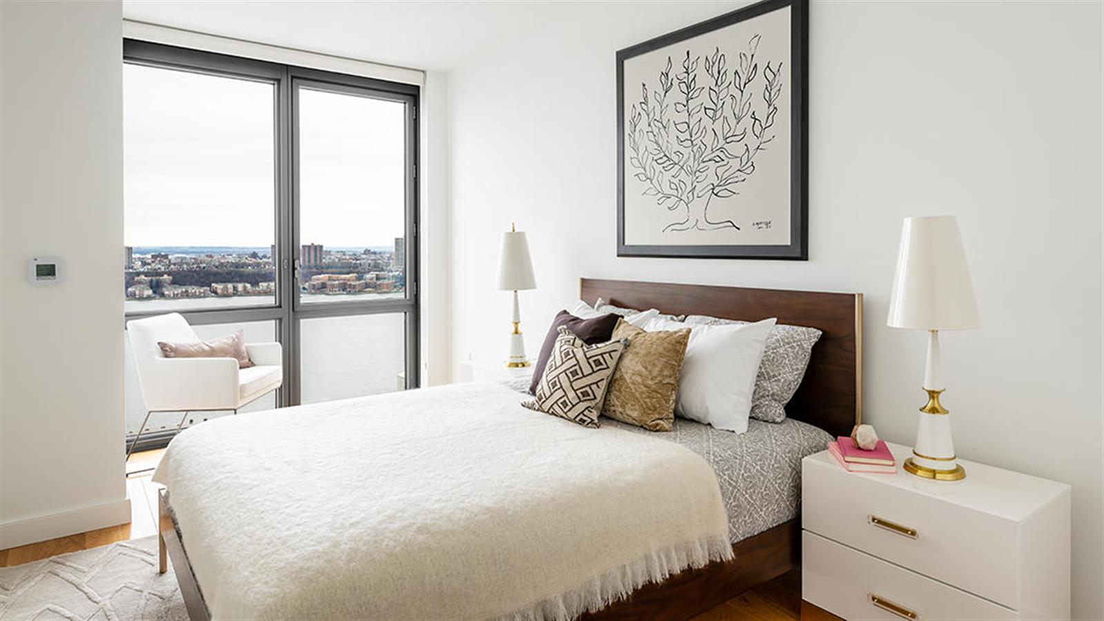 606 West 57th Street, Unit 1438 Manhattan, NY 10019 - Photo 5 of 23 a bedroom with a bed and a window