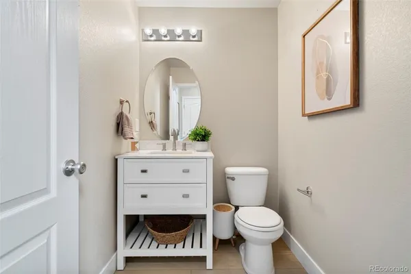 a bathroom with a toilet a sink and a mirror